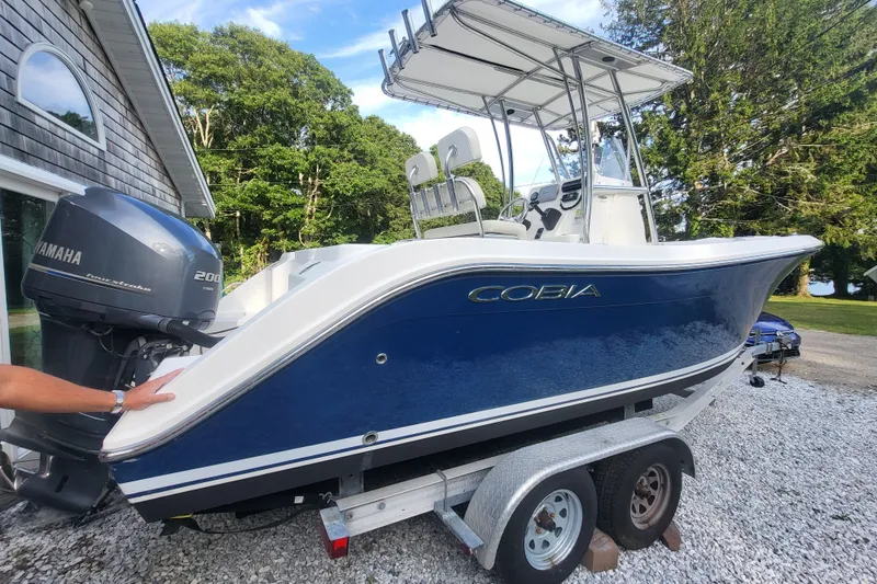 Slide: The Image of 2012 Cobia 217 Center Console boat with Yamaha 200 engine on trailer. - 3