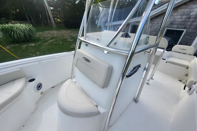 Slide: The Image of 2012 Cobia 217 Center Console boat interior with seating and console details. - 16