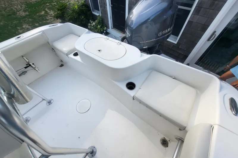Slide: The Image of 2012 Cobia 217 Center Console boat interior with seating and Yamaha engine. - 11