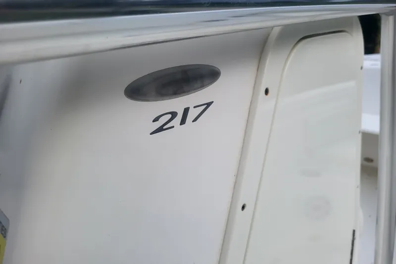 Slide: The Image of 2012 Cobia 217 Center Console boat detail, showcasing model number on white surface. - 27