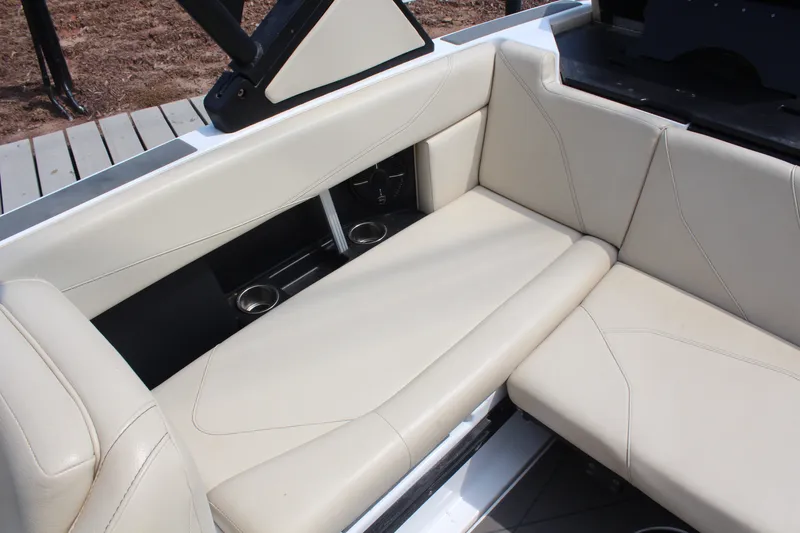 Slide: The Image of Luxurious seating in 2022 ATX Surf Boats 22 Type-S with cup holders and beige upholstery. - 13