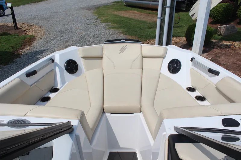 Slide: The Image of 2022 ATX Surf Boats 22 Type-S interior with beige seating and cup holders. - 19