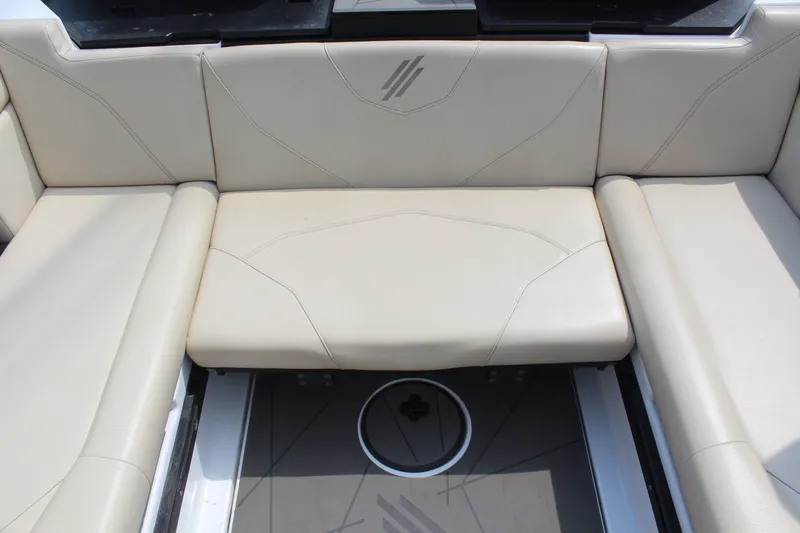 Slide: The Image of 2022 ATX Surf Boats 22 Type-S interior seating with beige upholstery and sleek design. - 14