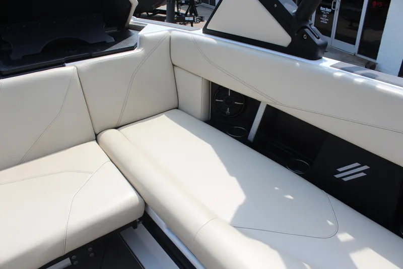 Slide: The Image of 2022 ATX Surf Boats 22 Type-S interior with beige seating and cup holders. - 12