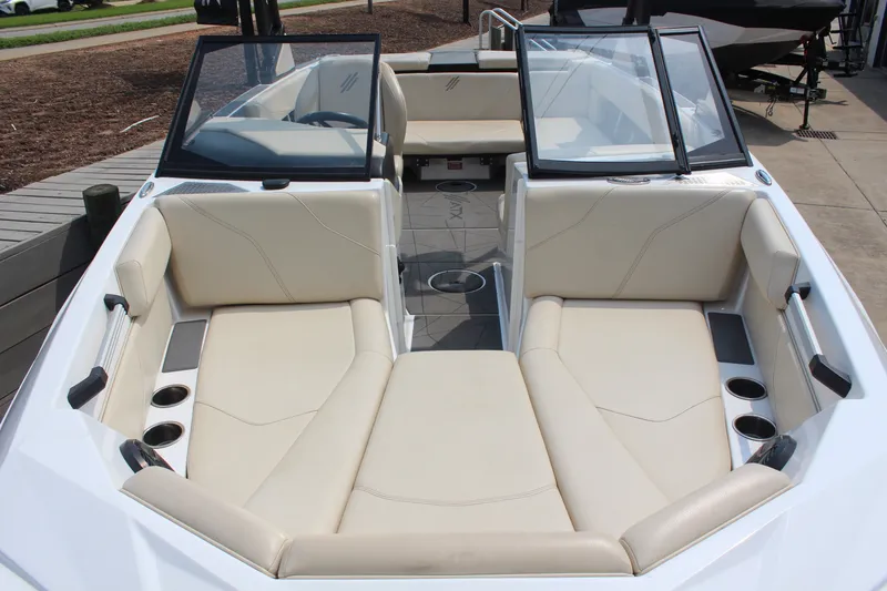 Slide: The Image of 2022 ATX Surf Boats 22 Type-S interior with beige seating and cup holders. - 7