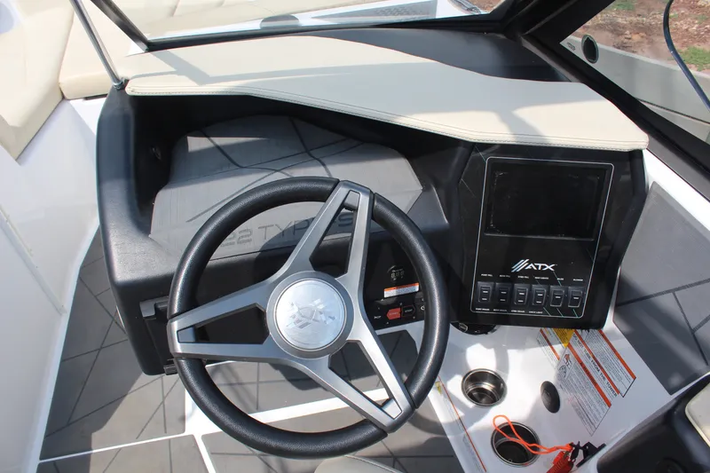 Slide: The Image of 2022 ATX Surf Boats 22 Type-S dashboard with steering wheel and control panel. - 16