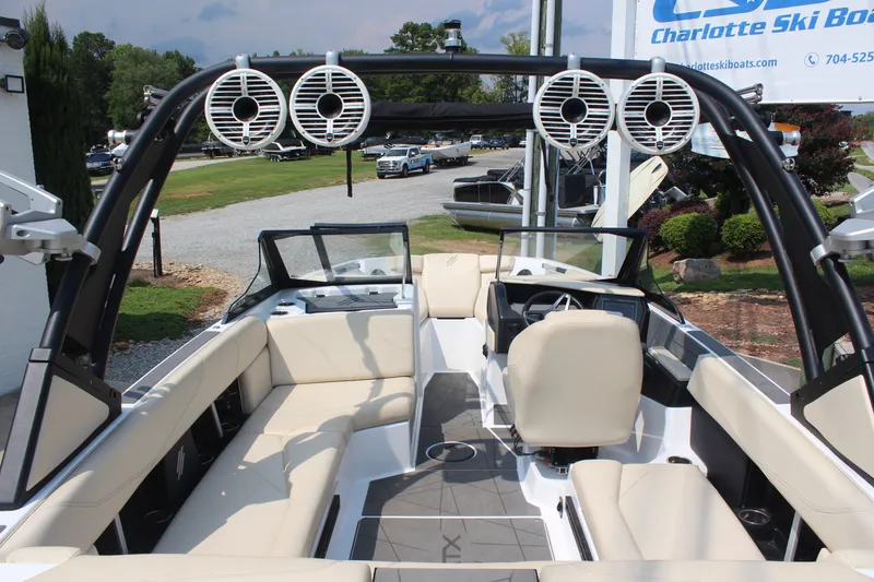 Slide: The Image of 2022 ATX Surf Boats 22 Type-S interior with beige seating and sleek design. - 4