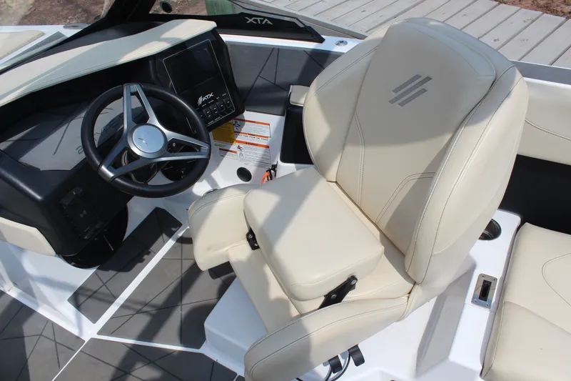 Slide: The Image of 2022 ATX Surf Boats 22 Type-S interior with steering wheel and beige seating. - 15
