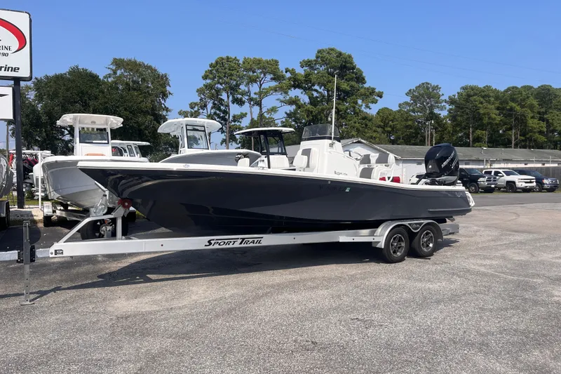 Slide: The Image of 2023 BlackJack 256 Bay boat on trailer in dealership lot, sunny day. - 2