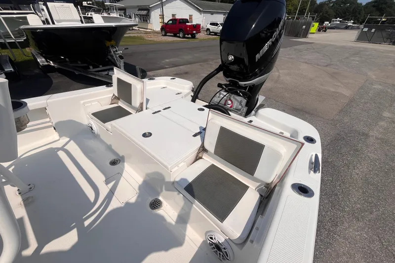 Slide: The Image of 2023 BlackJack 256 Bay boat with Mercury engine, featuring spacious seating and storage. - 18