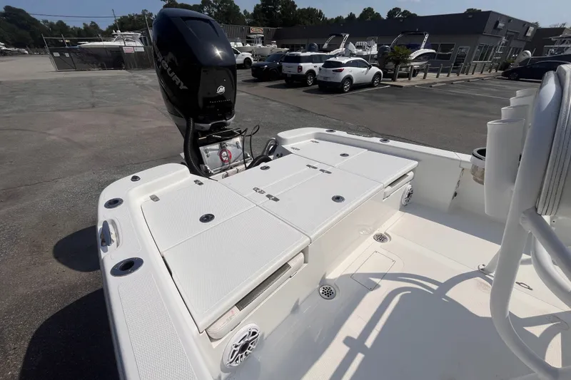 Slide: The Image of 2023 BlackJack 256 Bay boat with Mercury engine, parked in a dealership lot. - 6