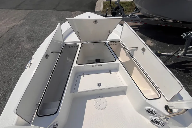 Slide: The Image of 2023 BlackJack 256 Bay boat with open storage compartments on deck. - 12