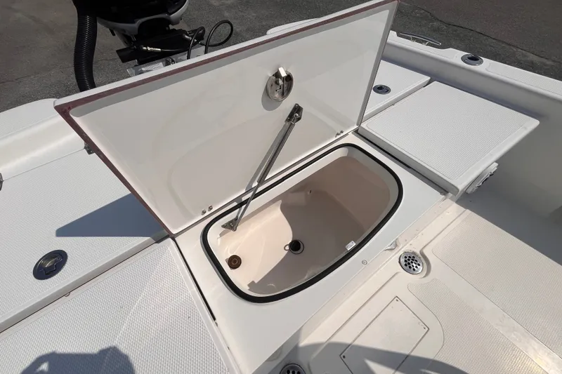 Slide: The Image of Open storage compartment on 2023 BlackJack 256 Bay boat deck. - 19