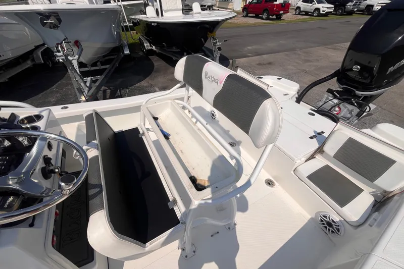 Slide: The Image of 2023 BlackJack 256 Bay boat interior with seating and steering wheel. - 17
