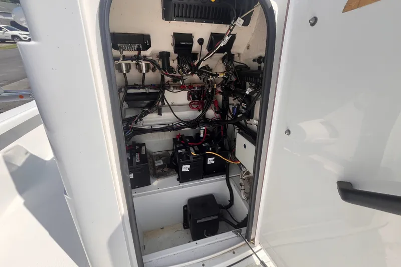 Slide: The Image of Interior view of 2023 BlackJack 256 Bay boat's electrical wiring and battery setup. - 14