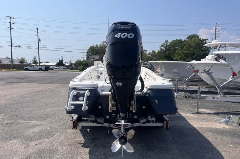 Slide: The Image of 2023 BlackJack 256 Bay boat with powerful 400 horsepower outboard motor, parked outdoors. - 4
