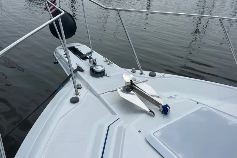 Slide: The Image of 1997 Formula 34 Performance Cruiser bow with anchor and railing on calm water. - 26
