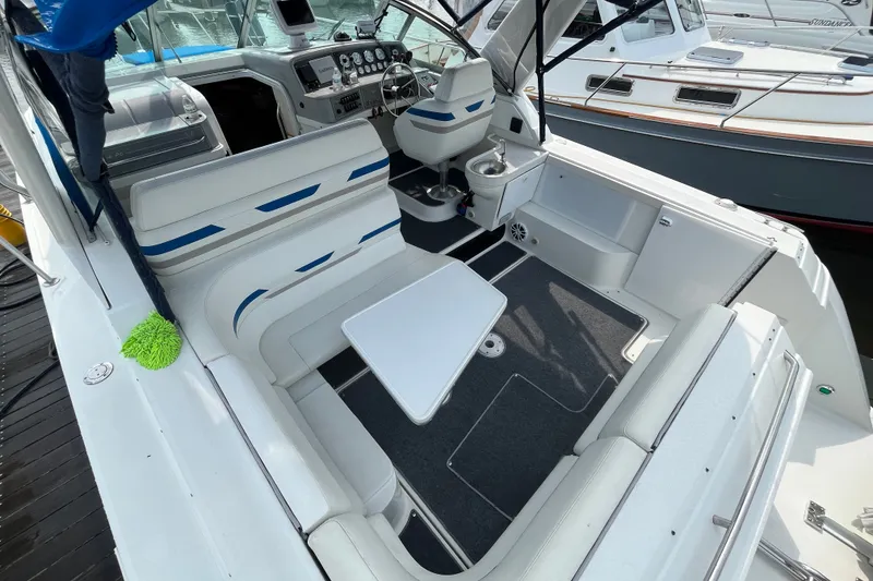 Slide: The Image of 1997 Formula 34 Performance Cruiser interior with seating, table, and helm controls. - 23