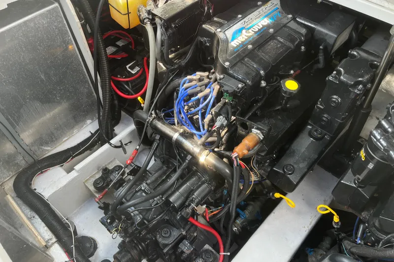 Slide: The Image of Engine compartment of a 1997 Formula 34 Performance Cruiser with visible wiring and components. - 32