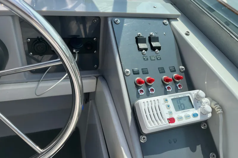 Slide: The Image of Control panel of a 1997 Formula 34 Performance Cruiser with steering wheel and electronic switches. - 17