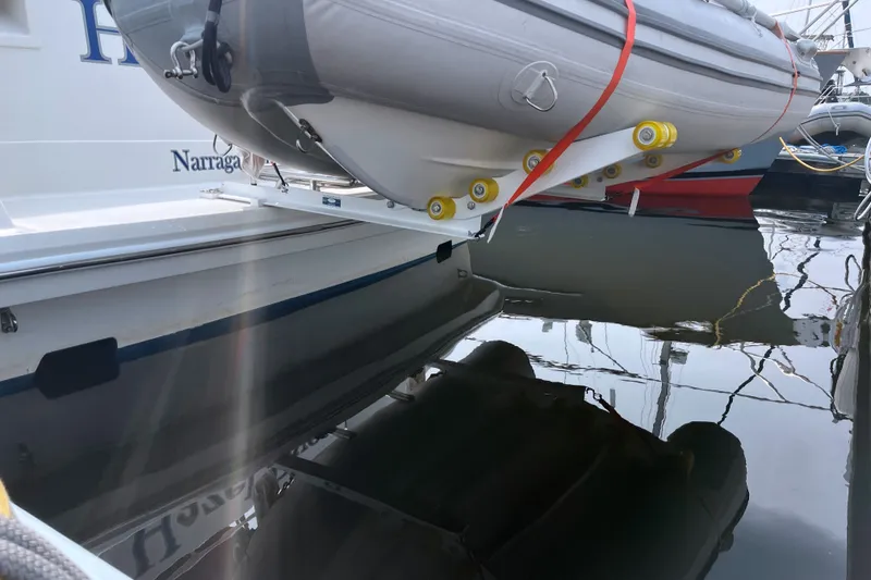 Slide: The Image of 1997 Formula 34 Performance Cruiser with dinghy, docked at marina, reflecting on water. - 28