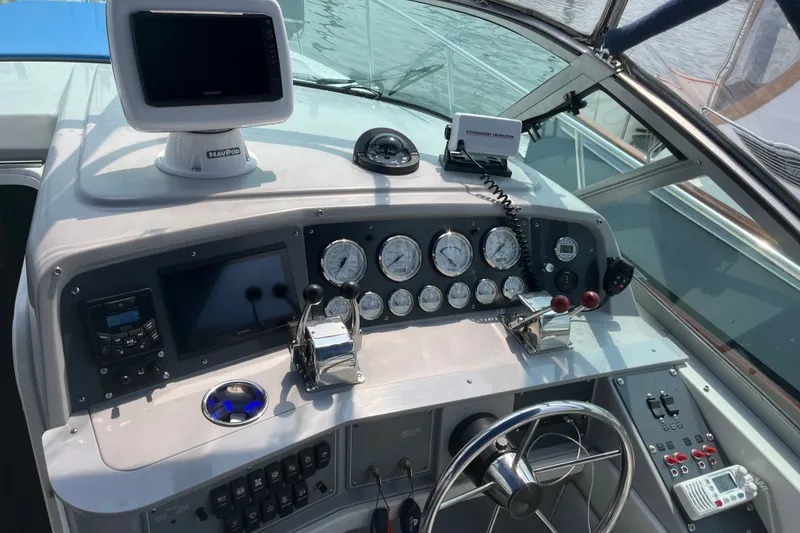 Slide: The Image of 1997 Formula 34 Performance Cruiser helm with gauges, steering wheel, and navigation equipment. - 16