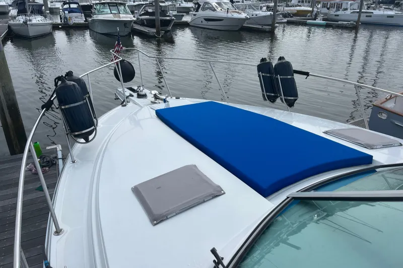 Slide: The Image of 1997 Formula 34 Performance Cruiser docked at marina, featuring blue sunpad and fenders. - 24