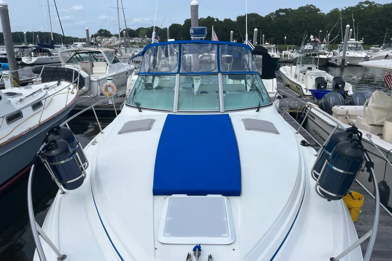 Slide: The Image of 1997 Formula 34 Performance Cruiser docked at marina, surrounded by other boats. - 25
