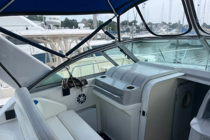 Slide: The Image of 1997 Formula 34 Performance Cruiser interior with marina view, featuring seating and helm area. - 21