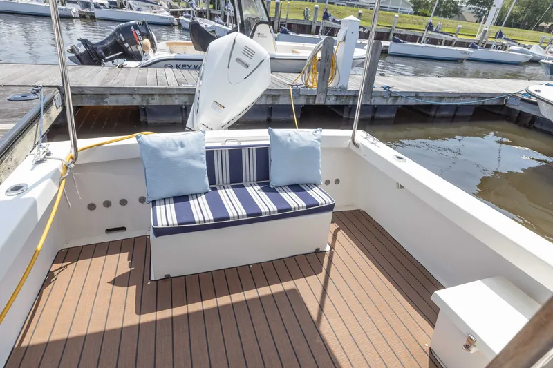 Slide: The Image of 2019 Rosborough 246 Halifax boat interior with striped seating at marina. - 17