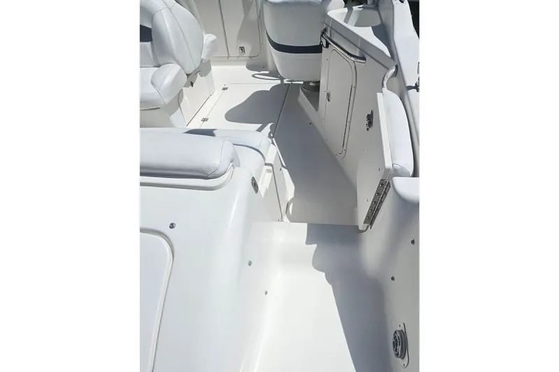 Slide: The Image of 2003 Chaparral 215 SS boat interior with white seating and storage compartments. - 7