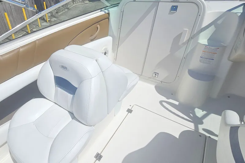 Slide: The Image of Interior of a 2003 Chaparral 215 SS boat with white seating and storage compartment. - 10