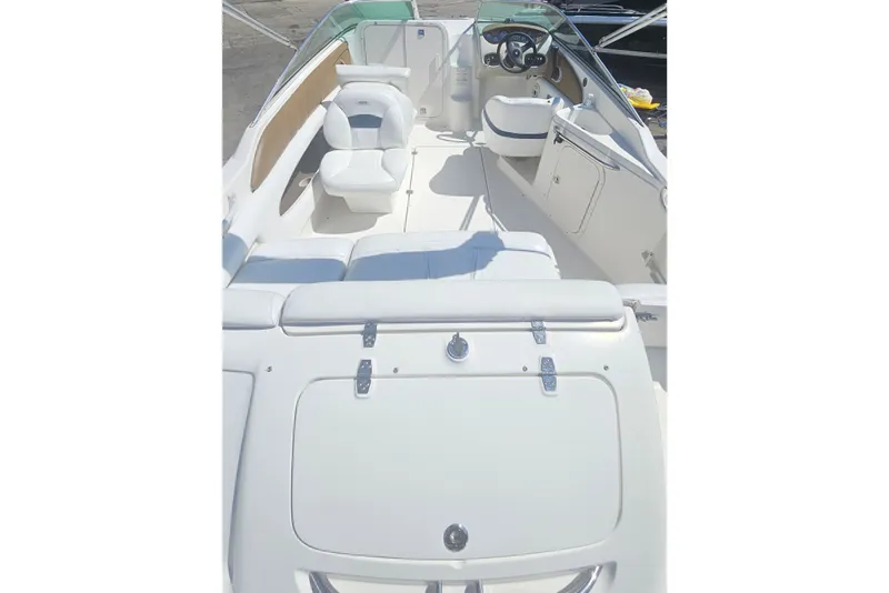 Slide: The Image of 2003 Chaparral 215 SS boat interior with white seating and steering console. - 6