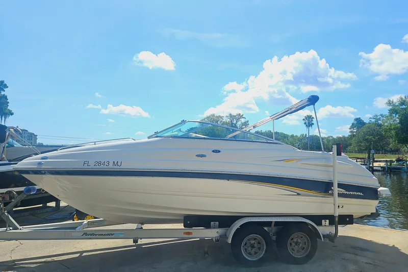 Slide: The Image of 2003 Chaparral 215 SS boat on trailer under clear blue sky. - 3