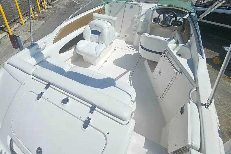 Slide: The Image of 2003 Chaparral 215 SS boat interior with white seating and steering wheel. - 8
