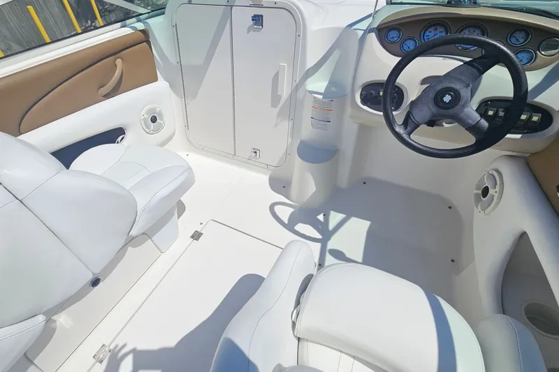 Slide: The Image of Interior of 2003 Chaparral 215 SS boat with white seating and steering wheel. - 24