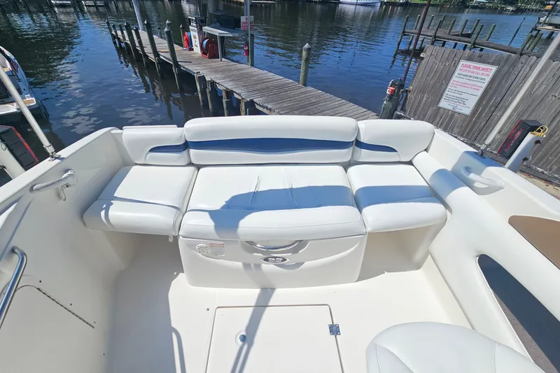 Slide: The Image of 2003 Chaparral 215 SS boat interior with white seating, dockside view. - 19