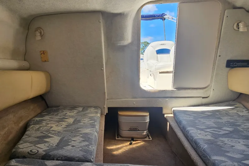 Slide: The Image of Interior cabin of 2003 Chaparral 215 SS boat with seating and portable toilet. - 25