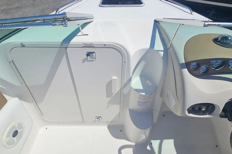 Slide: The Image of 2003 Chaparral 215 SS boat interior, featuring helm and cabin door. - 18