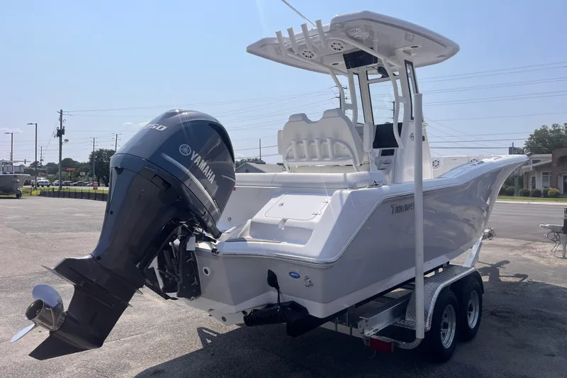 Slide: The Image of 2027 Tidewater 232 LXF boat with Yamaha engine on trailer, parked outdoors. - 4