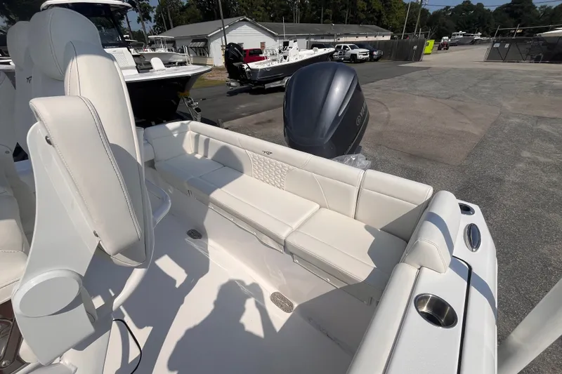 Slide: The Image of 2027 Tidewater 232 LXF boat interior with white seating and Yamaha outboard motor. - 5