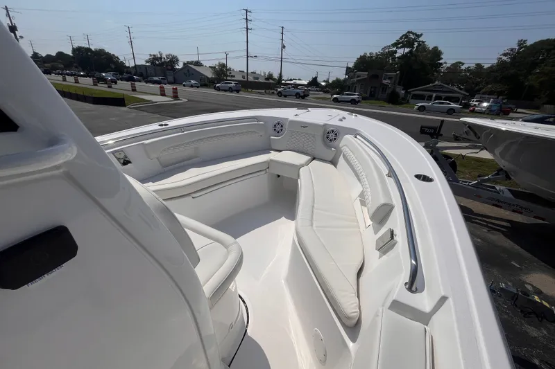 Slide: The Image of 2027 Tidewater 232 LXF boat interior with white seating and modern design. - 13