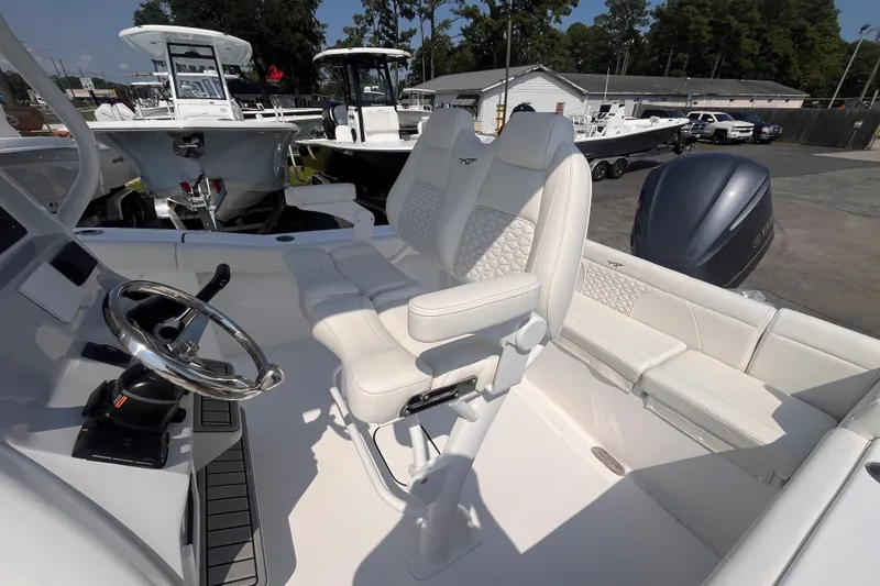 Slide: The Image of 2027 Tidewater 232 LXF boat interior with white seating and steering wheel. - 6