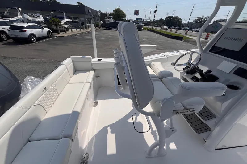 Slide: The Image of 2027 Tidewater 232 LXF boat interior with white seating and Garmin navigation system. - 15