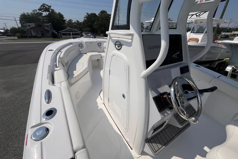Slide: The Image of 2027 Tidewater 232 LXF boat interior with steering wheel and seating area. - 9