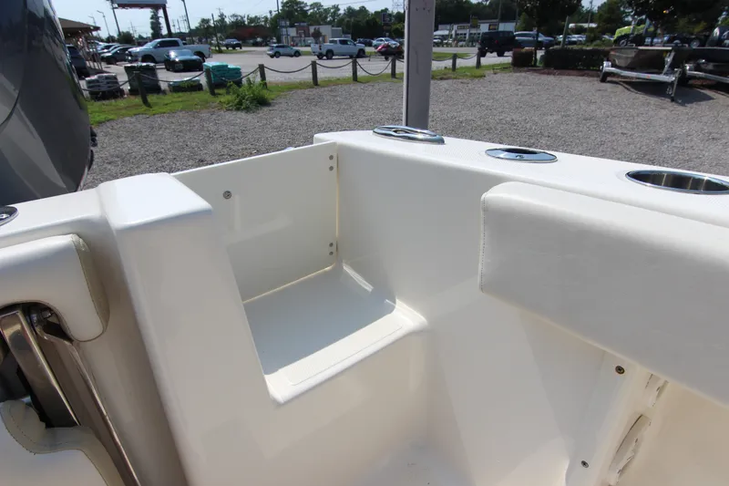 Slide: The Image of 2024 Bulls Bay 255 Center Console boat interior with cup holders and seating area. - 14