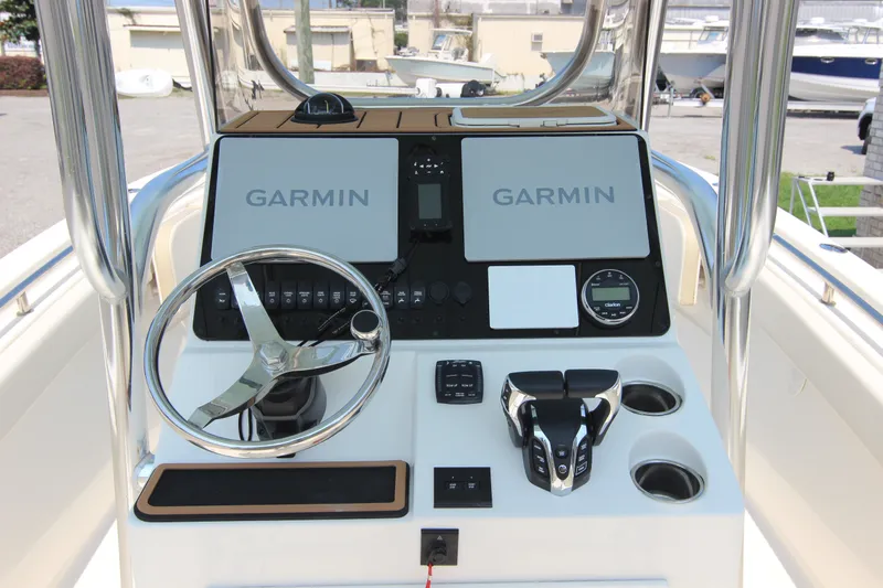 Slide: The Image of 2024 Bulls Bay 255 Center Console boat dashboard with Garmin navigation system and steering wheel. - 22