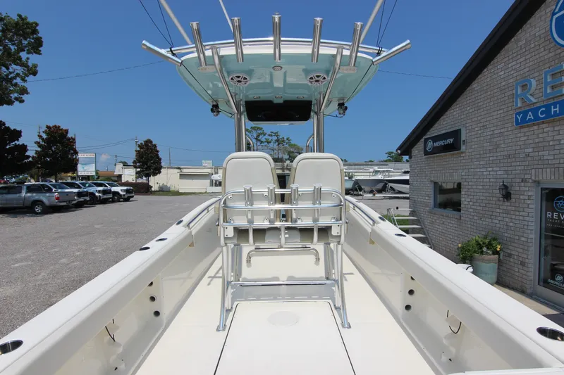 Slide: The Image of 2024 Bulls Bay 255 Center Console boat at a dealership, showcasing seating and console features. - 16