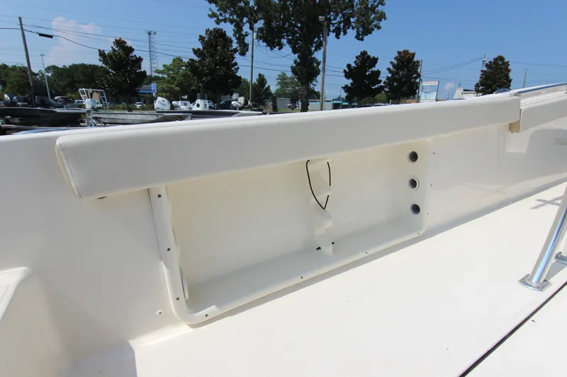 Slide: The Image of 2024 Bulls Bay 255 Center Console boat interior with storage compartment and rod holders. - 17