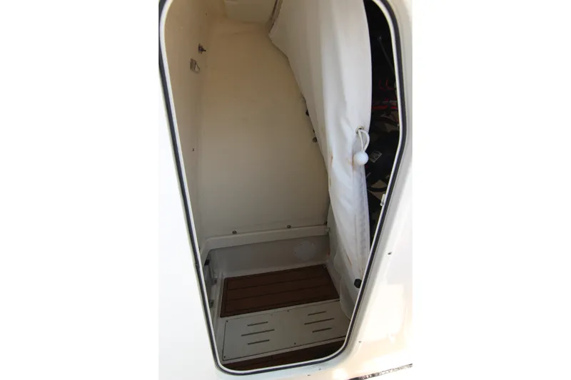 Slide: The Image of Interior cabin of 2024 Bulls Bay 255 Center Console boat, featuring a compact space. - 36